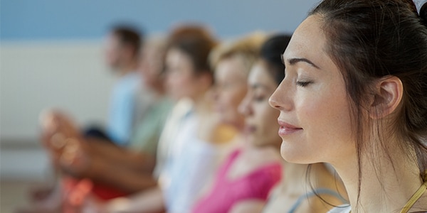 Female leaders practising mindfulness as they learn how to achieve a healthy work life balance 