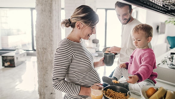 Family cooking dinner for child